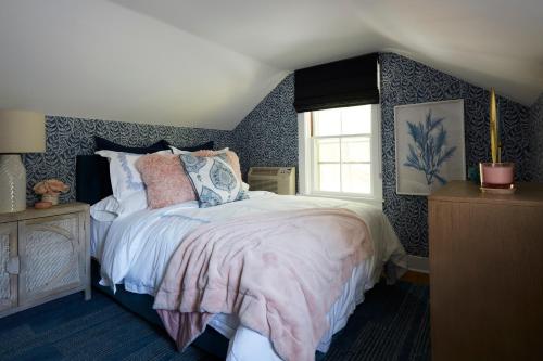 a bedroom with a bed and a window at The Cornell Inn, Lenox & The Berkshires in Lenox