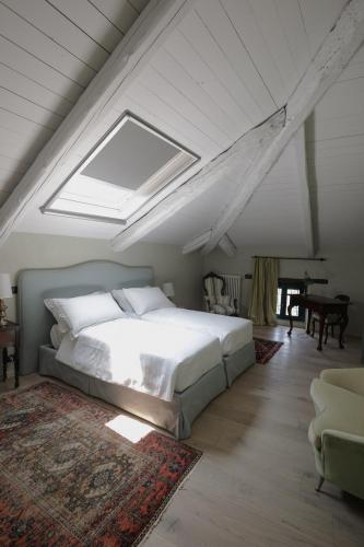 a bedroom with a large bed and a skylight at Pampucet in Colcavagno