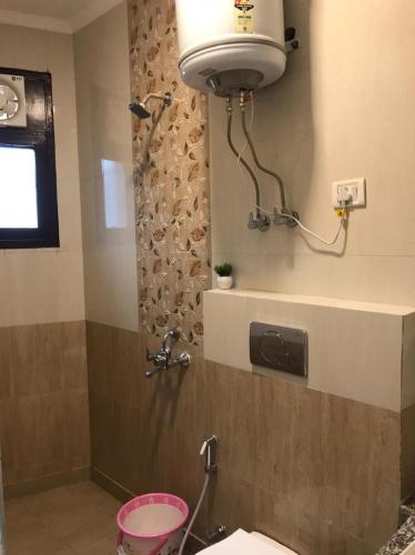 a bathroom with a shower with a toilet and a sink at The Divine Oak in Katra