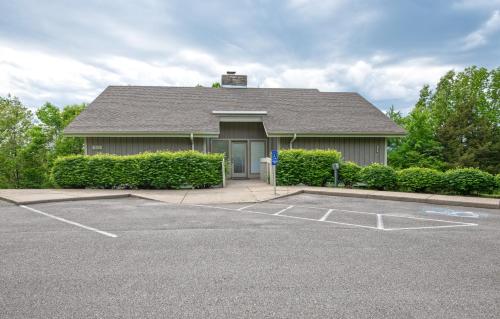 a house with a parking lot in front of it at Barren River Lake State Resort Park in Lucas