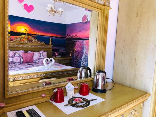 a bedroom with a bed with a swan in a mirror at Petite Flower Guest House in Talata-maty