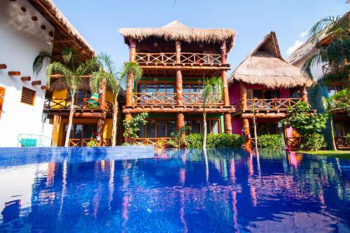 a resort with a swimming pool in front of a building at Soho Boutique Holbox - Adults Only in Holbox Island