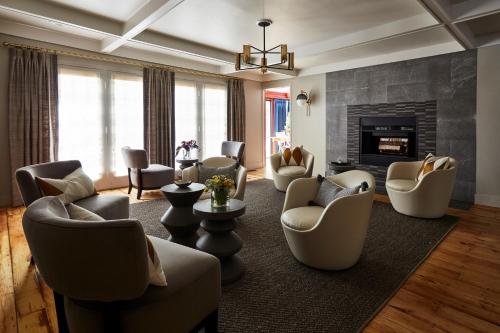 a living room with chairs and a fireplace at The Cornell Inn in Lenox