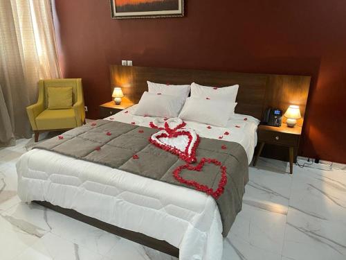 a bedroom with a large bed with two hearts on it at RESIDENCE SYCOMORE 1 in Abidjan