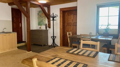 a kitchen and dining room with a table and chairs at Ubytování Smrk in Nové Město pod Smrkem