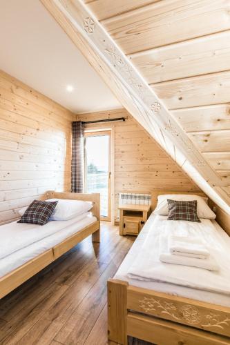 a room with two beds and a staircase at Domki Tatrzański Przystanek in Białka Tatrzanska