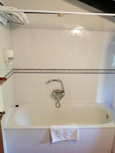 a bath tub with a faucet in a bathroom at El Caserío in Camaleño