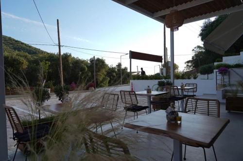 a patio with tables and chairs on a roof at Kiperi Exclusive in Parga