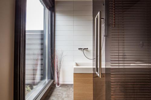 a bathroom with a sink and a shower at Reelinki Seafront Villa Aava in Pori