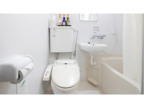 a white bathroom with a toilet and a sink at HOTEL Nishikawaguchi Weekly - Vacation STAY 44797v in Saitama