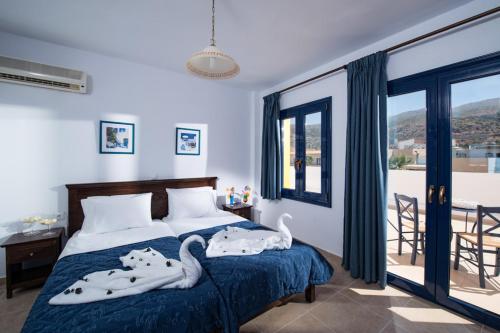 um quarto com uma cama com cisnes em Aegean Sky Hotel-Suites em Malia