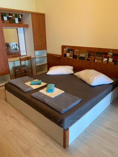 a bed in a room with two towels on it at Seafront aparment in Podgora