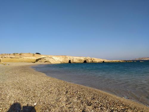 a group of people standing on a rocky beach at Kyanis Villa , Karpathos Afiartis in Afiartis