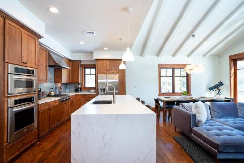 a kitchen and living room with a couch and a table at New Listing! Luxury 3BD Residence on Gray's Crossing Golf Course in Truckee