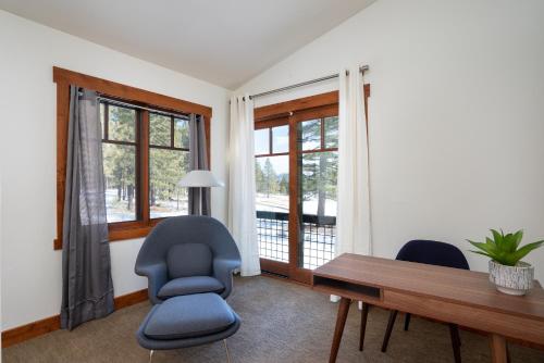 a room with two chairs and a table and windows at New Listing! Luxury 3BD Residence on Gray's Crossing Golf Course in Truckee