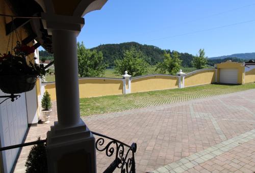 a balcony of a house with a yellow and white railing at Appartements Panorama Schlössl in Velden am Wörthersee