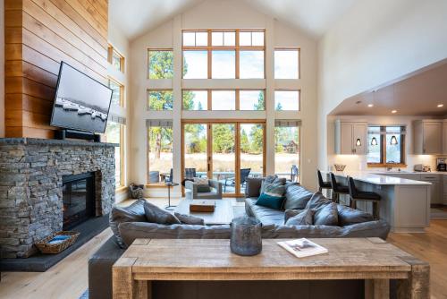 a living room with a couch and a fireplace at NEW 4BD Residence in the Signature Home Collection at Old Greenwood! in Truckee