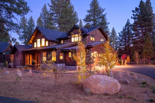a large house with lights in front of it at New Listing In The NEW Signature Collection At Old Greenwood! in Truckee