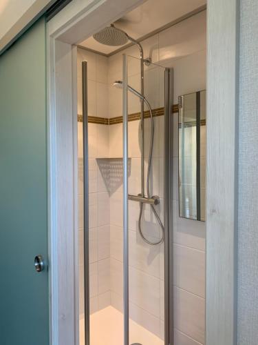 a shower with a glass door in a bathroom at Weingut Stiftshof in Enkirch