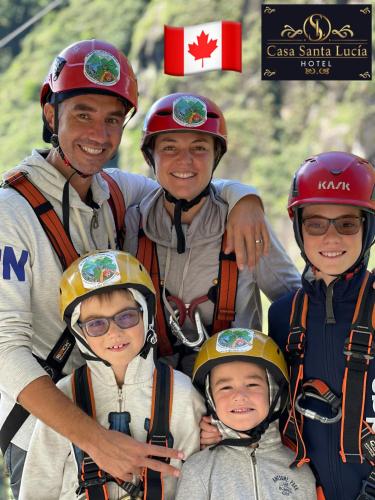 a man and four children wearing helmets on a mountain at Hotel Casa Santa Lucía in Baños
