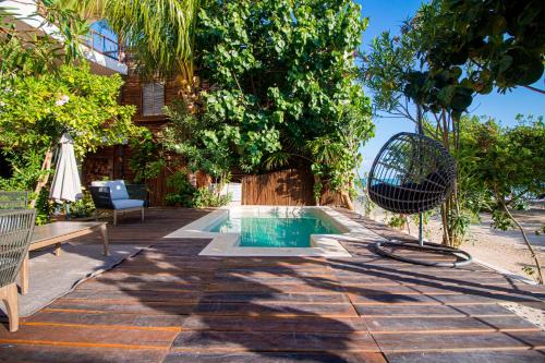 a pool in the middle of a patio with a tree at Spirit Holbox in Holbox Island