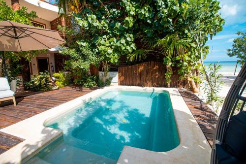 a swimming pool in the backyard of a house at Spirit Holbox in Holbox Island