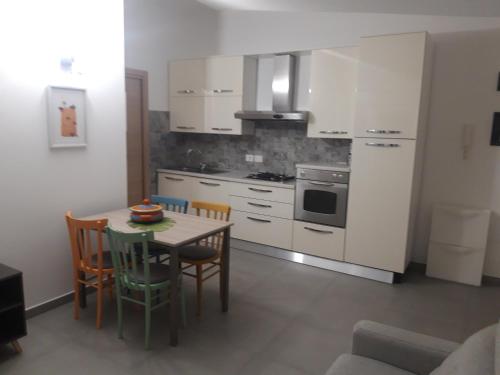 a kitchen with a table and chairs in a room at Dolce Brezza in Montesilvano