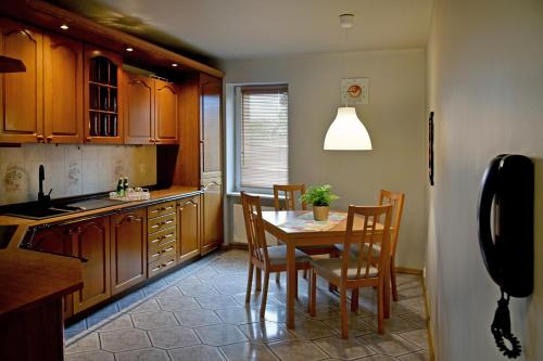 a kitchen with a table and chairs and a window at Apartament Młyńska 59 in Koszalin