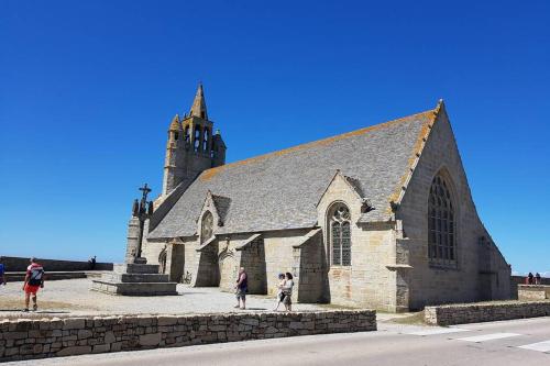 a church with people standing in front of it at Penty bigouden 18ème classé 2** jardin en ville in Pont-lʼAbbé