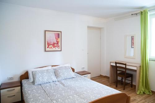 Postel nebo postele na pokoji v ubytování Apartmani Vrtodusic