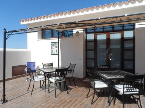 a patio with a table and chairs on a deck at Villa Al Mare Guest House in Tre Fontane
