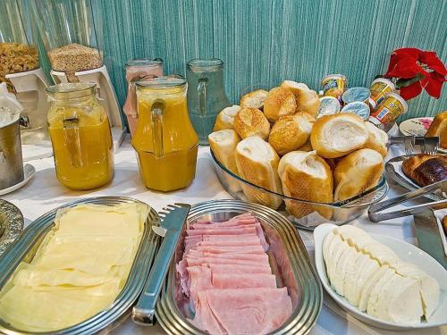 a table topped with different types of food and bread at Gran Chevalier Hotel in Sao Paulo