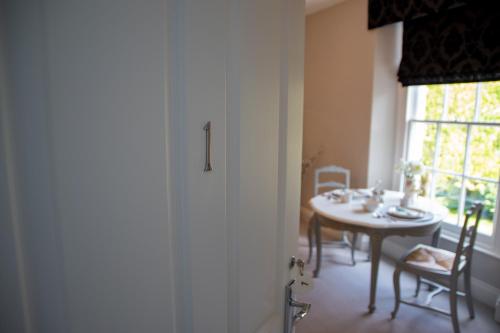 a dining room with a table and a window at Apple Tree Bed and Breakfast in Tavistock