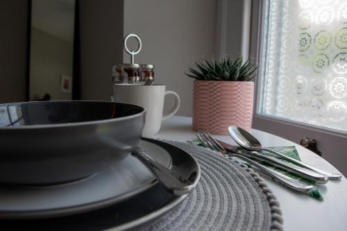 a bowl on a plate on a table with silverware at Apple Tree Bed and Breakfast in Tavistock