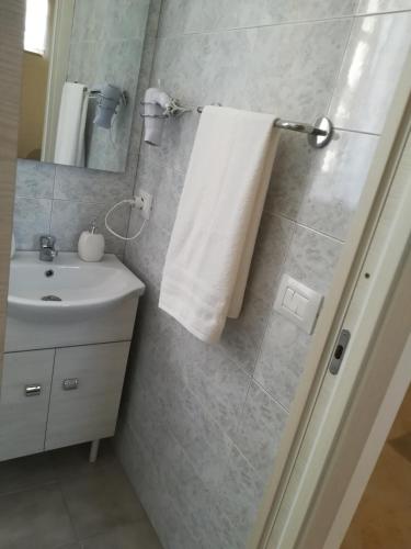 a bathroom with a sink and a white towel at Casa Vacanza Da Sofì in Cerda