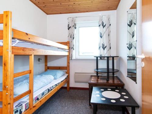 a bedroom with two bunk beds and a window at 10 person holiday home in Harboøre-By Traum in Harboør