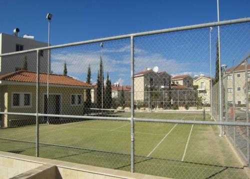 a tennis court with a net on a tennis court at Protaras Villa Angela Nefeli in Paralimni