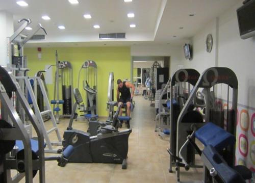 a man sitting on a treadmill in a gym at Protaras Villa Angela Nefeli in Paralimni