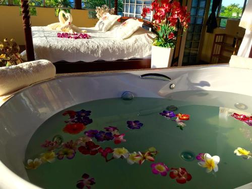 eine Badewanne mit Blumen und einem Bett in der Unterkunft Ever dreamed of staying in a 3 Bedroom Castle-SDV044B-By Samui Dream Villas in Koh Samui 
