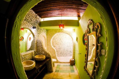 a bathroom with two sinks and a mirror at Bali Bohemia Huts in Ubud