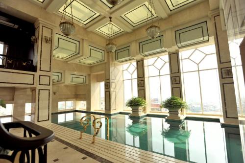 a large indoor pool with plants in a building at Eldora Hotel in Hue