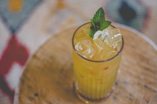 a drink sitting on top of a wooden table at Mercure Gerringong Resort in Gerringong