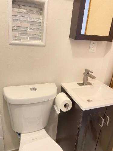 a bathroom with a white toilet and a sink at Beautiful House with Fantastic view in Azusa in Azusa