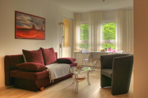 a living room with a couch and a table at Apartment am Großen Garten Dresden in Dresden