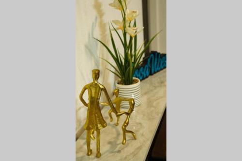 a gold couple statue next to a potted plant at Dallas 4BR Large yard w HOT TUB , Fire pit and basketball Hoop in Dallas