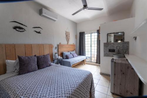 a bedroom with a bed and a chair and a mirror at Habitaciones Samy in San Francisco