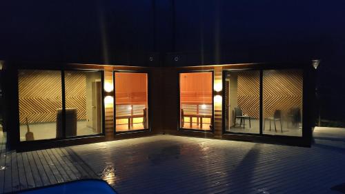 a room with three windows and a patio with a table at Chalet Venterivka in Tatariv