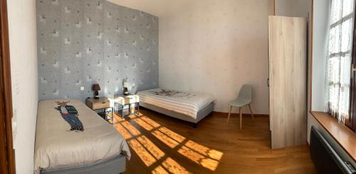 a small room with two beds and a window at Chambres D'hotes & Champagne Douard in La Chapelle-Monthodon