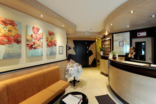 
a living room filled with furniture and a painting on the wall at Bon Port in Montreux
