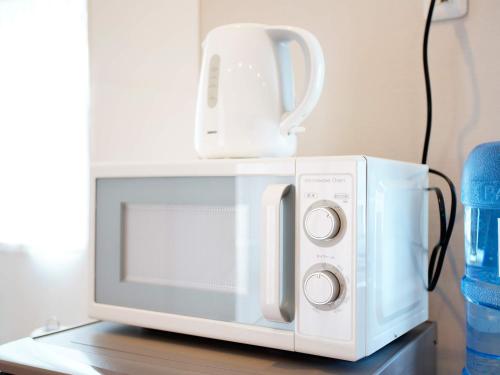 a white microwave with a jug on top of it at Mcity in Furujima in Naha